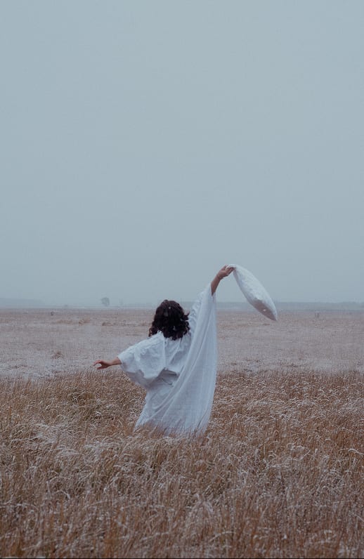 Person in a white dress on a frosty field
